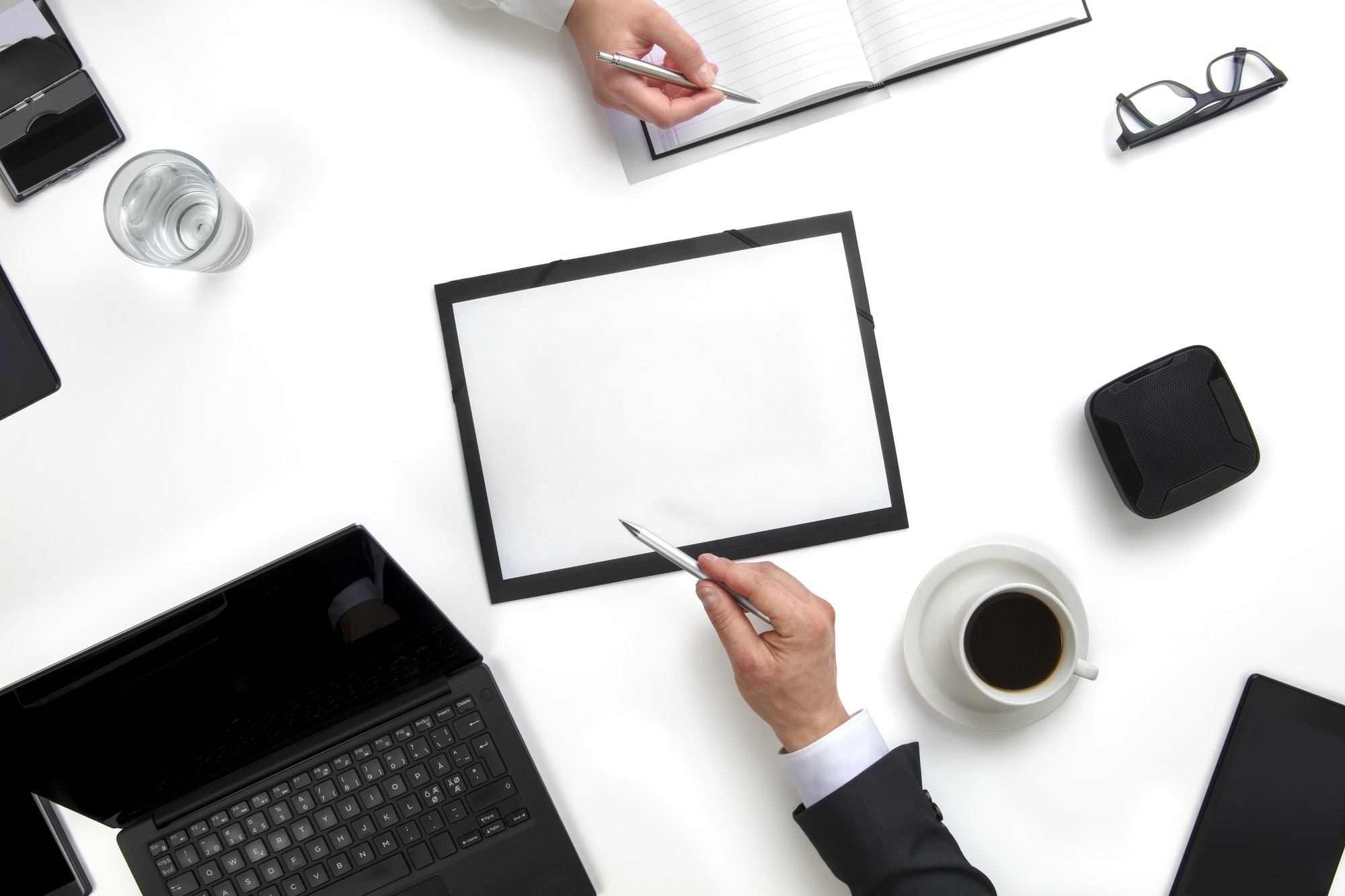 Business Colleagues Discussing Working On Documents At Desk